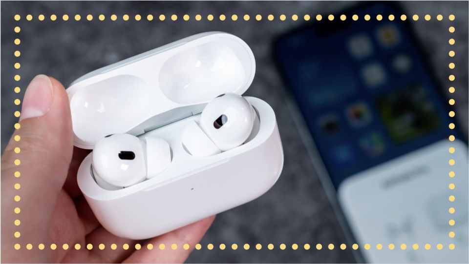 hand holding AirPods Pro pairing them with an iPhone