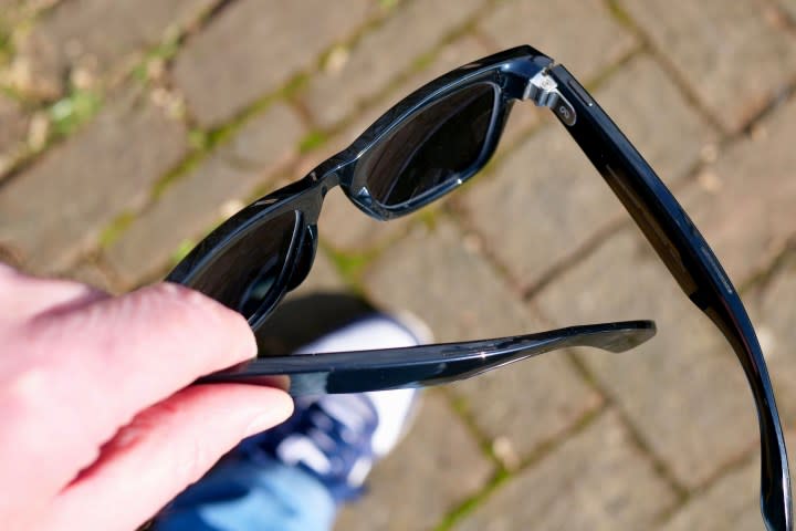 A person holding the Ray-Ban Meta smartglasses.