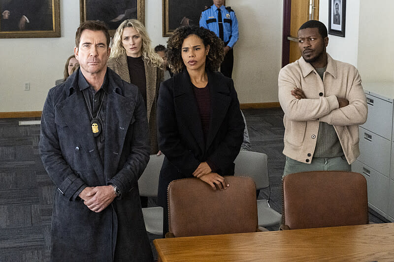 Dylan McDermott, Shantel VanSanten, Roxy Sternberg and Edwin Hodge, looking uneasy, face the camera in an office room lined with oil paintings.  