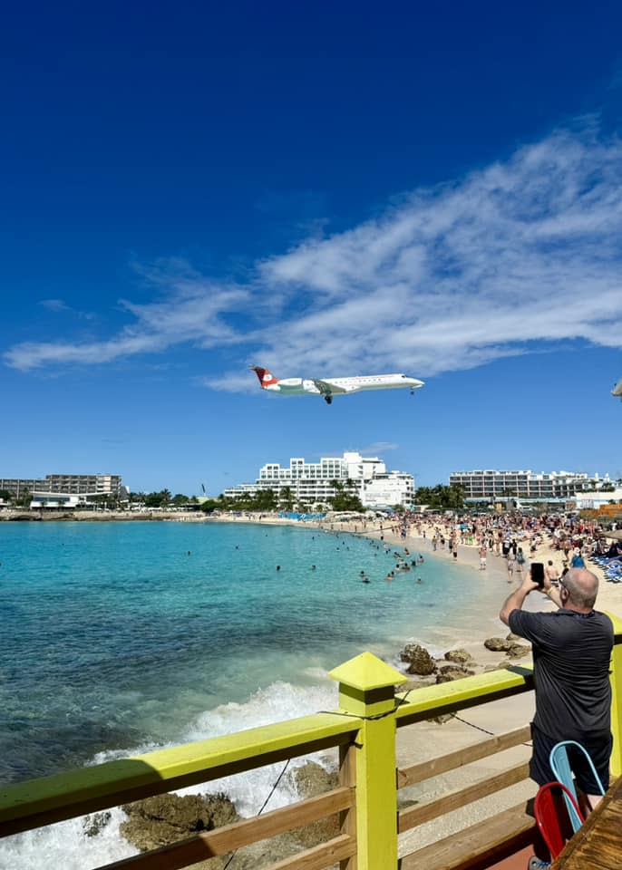 Plane flies above Maho Beach