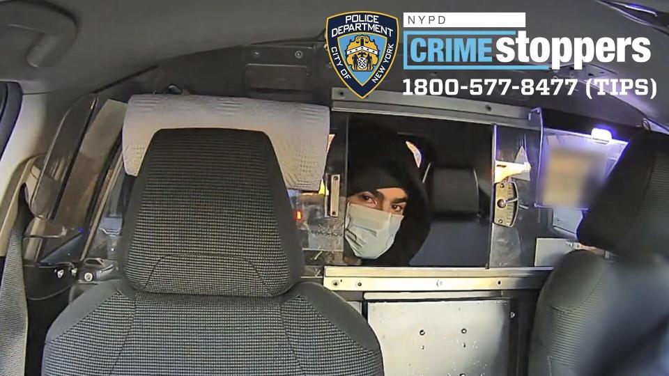 This undated photo released by the New York Police Department shows a suspect in the fatal shooting of UnitedHealthcare CEO Brian Thompson on Dec. 4, 2024, in a taxi. Part of the image was blurred by the source. (NYPD via AP)