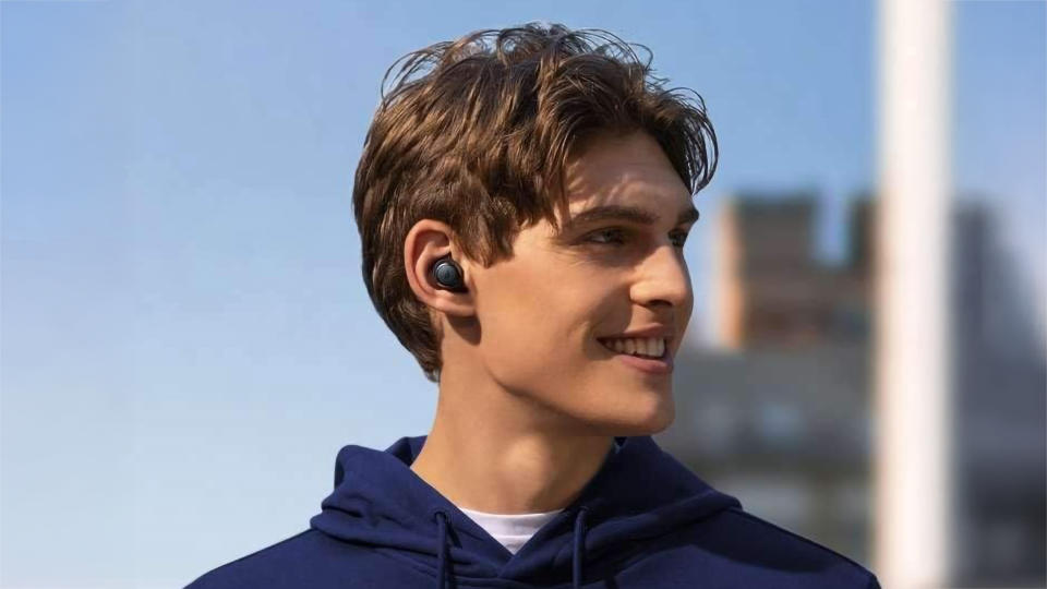 Young man wearing Soundcore earbuds