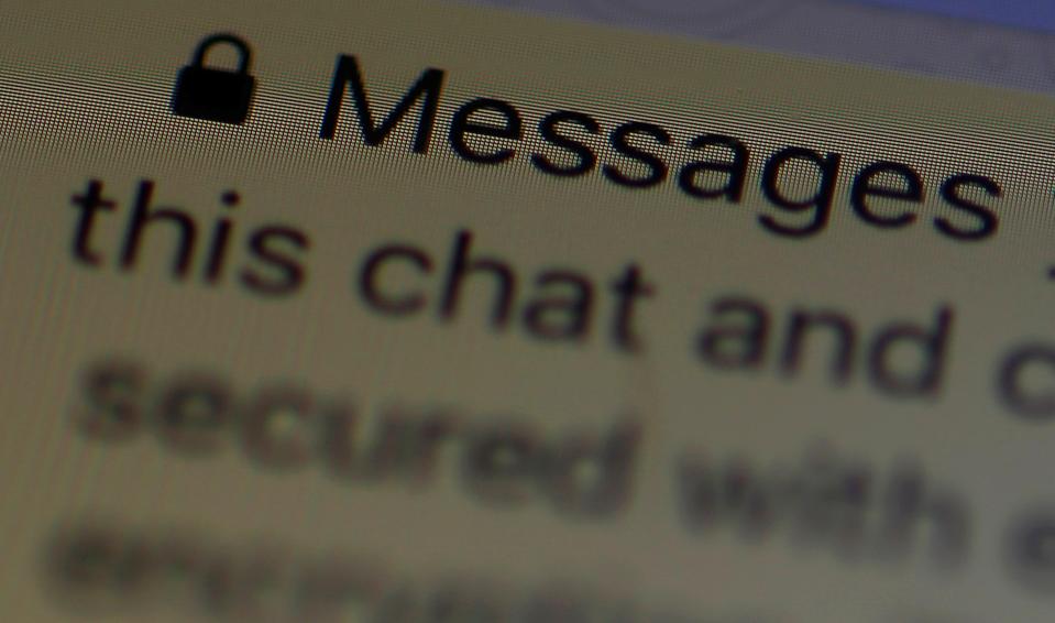 An encryption message is seen on the WhatsApp application on an iPhone in Manchester, Britain March 27, 2017.