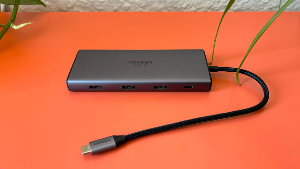 UGreen Revodok Pro 109 usb-c hub sits on an orange background. 