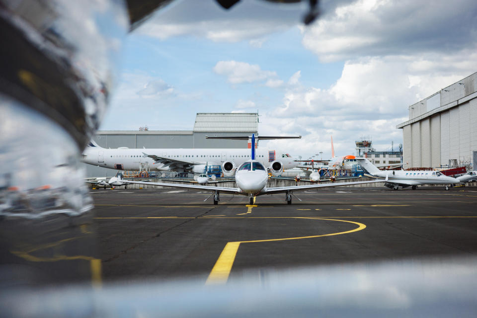 View of private airplanes parked on an airport tarmac, showcasing general aviation and luxury business travel.