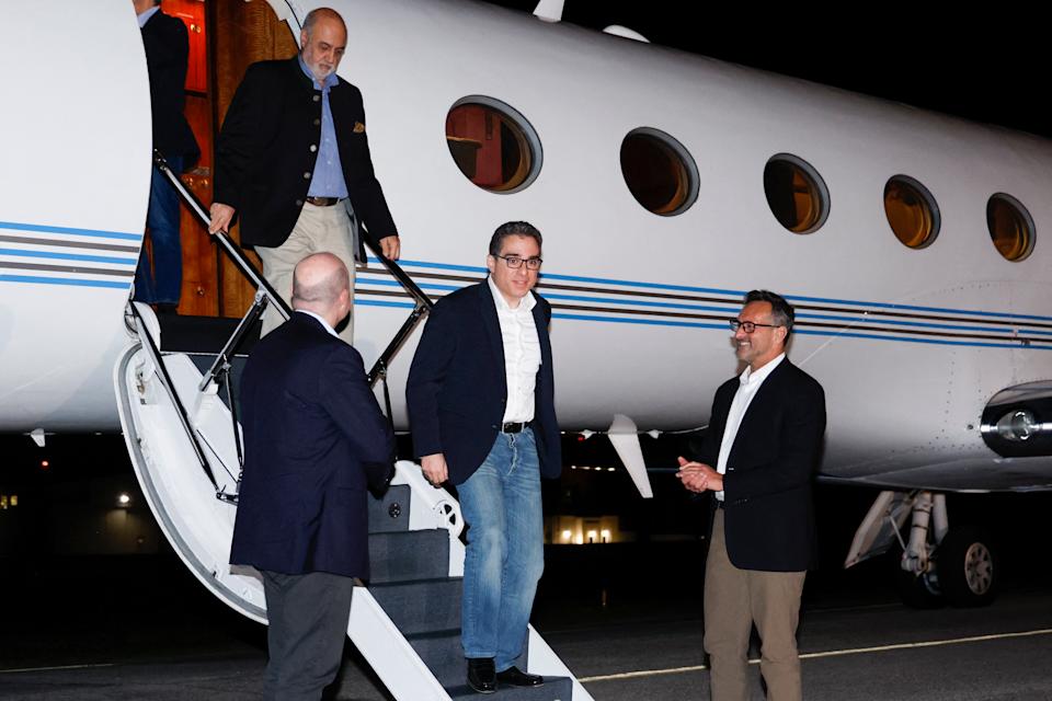 US Special Presidential Envoy for Hostage Affairs Roger Carstens (R) greets freed US Siamak Namazi (C) as he disembarks from an airplane at Davison Army Airfield at Fort Belvoir, Virginia, on September 19, 2023.