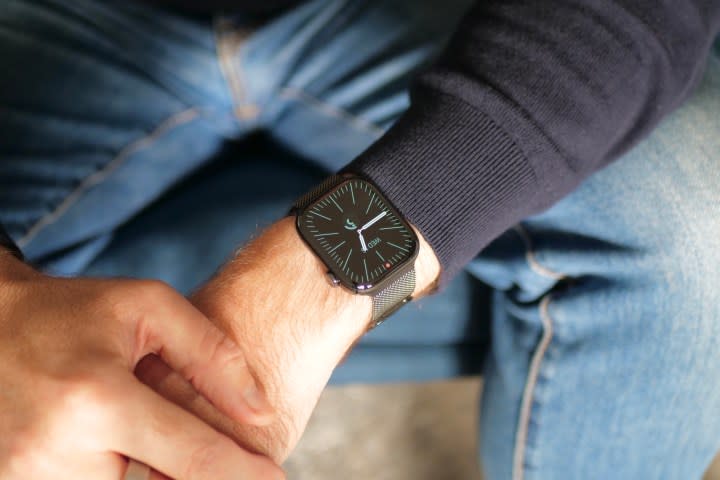 A person wearing the titanium Apple Watch Series 10.