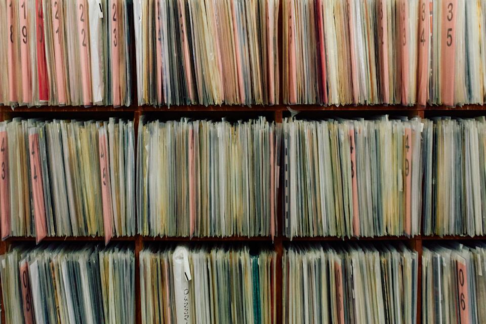 Shelves filled with records in plastic sleeves.