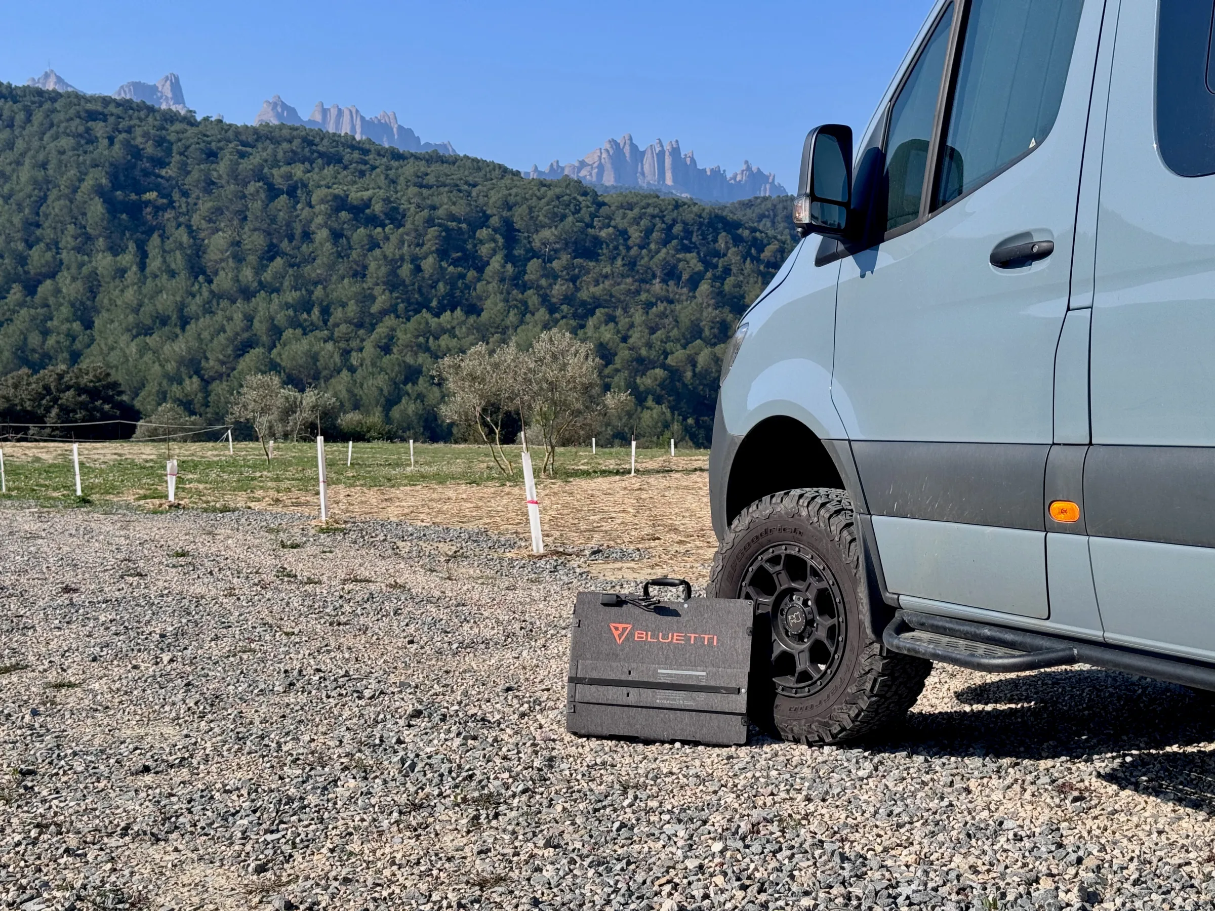 The Bluetti Sora 500 solar panel unfolded in a field showing its 12-panel grid structure 2026