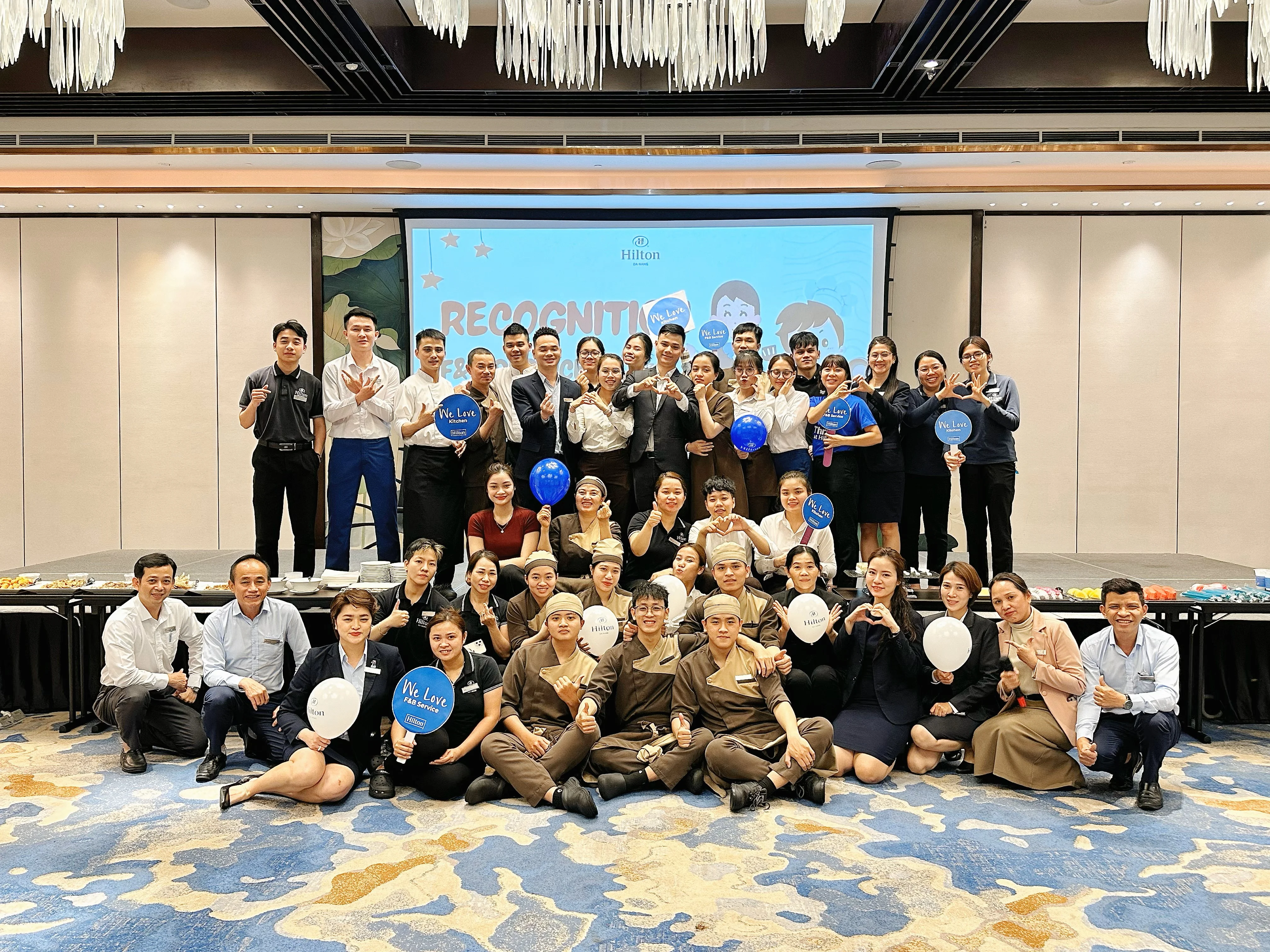 Hilton team members celebrating corporate culture in a vibrant Vietnam hotel setting