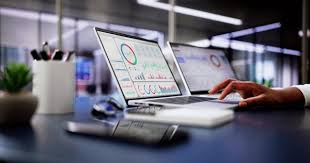 Two Sonos Play speakers positioned on grass in front of a sage colored bag in a 2026 setting